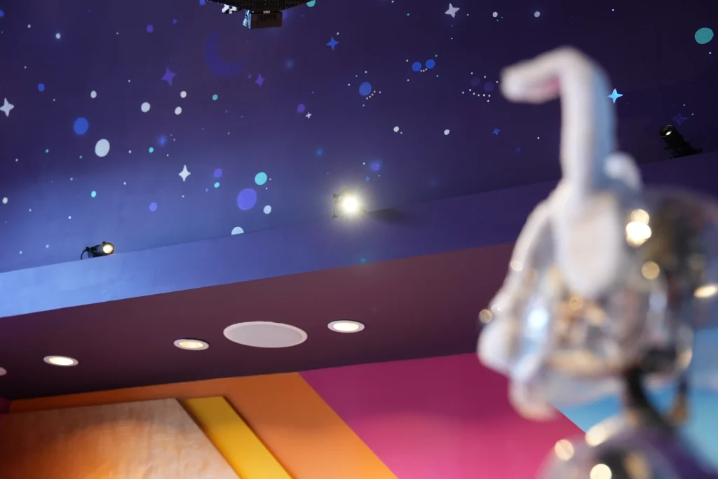 Children exploring STEAM activities under Gantom lighting in WonderLab